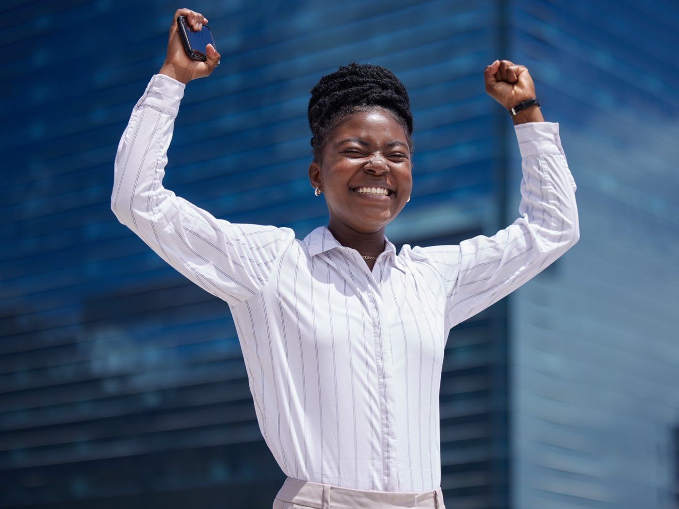 Joyful Black woman celebrating a personal milestone (editorial placeholder image)